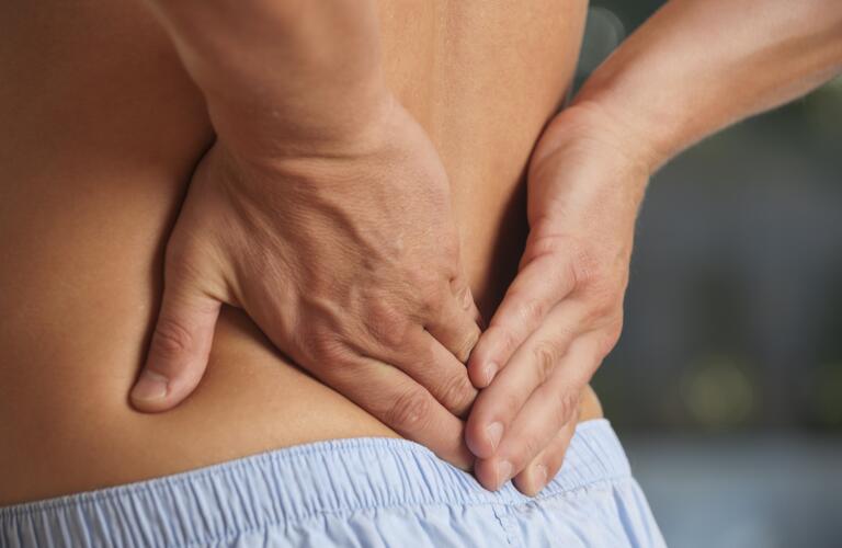 Male rubbing his lower back