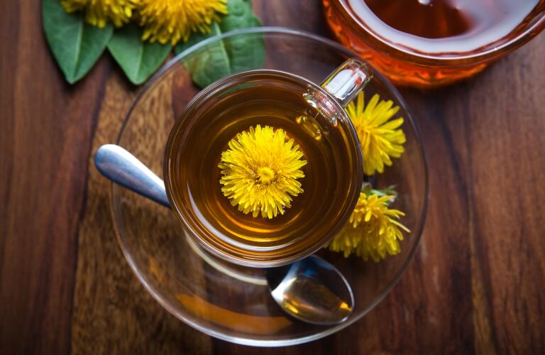 dandelion tisane tea with yellow blossom inside teacup