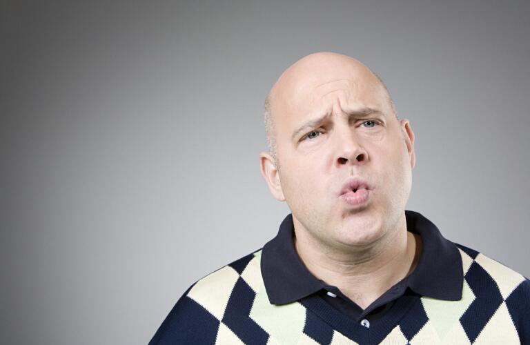 Middle aged Caucasian man pursing lips