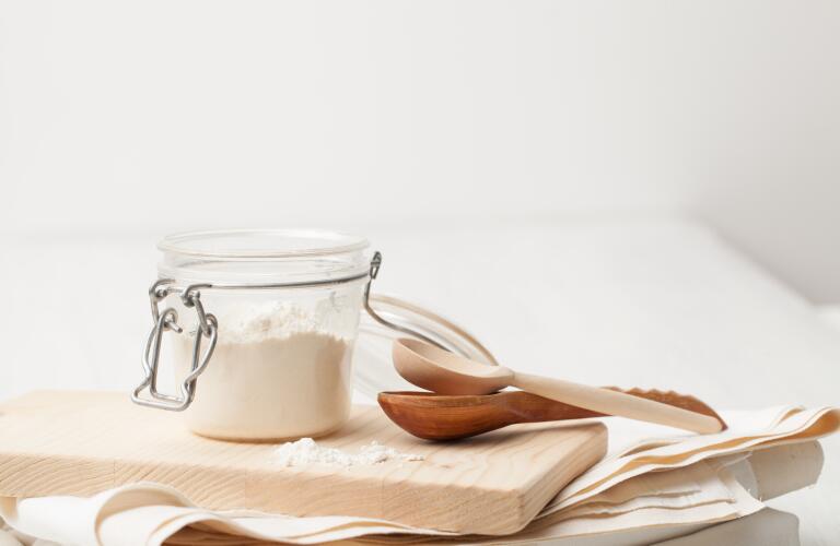 jar of homemade cleanser with wooden spoons