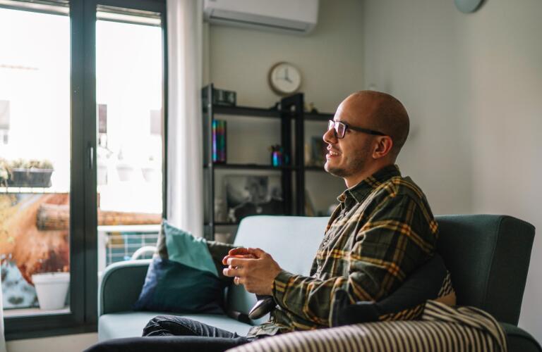 Man in apartment playing video games alone