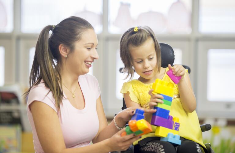 therapist-playing-with-girl-with-cerebral-palsy