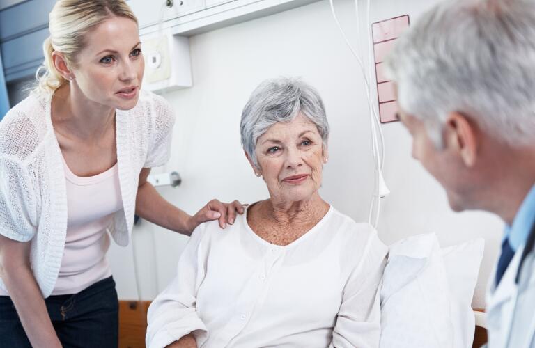 mother and daughter talking to doctor