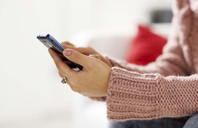 Asian girl reading sms on smarthphone