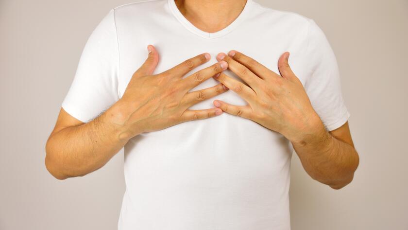 man with hands on chest