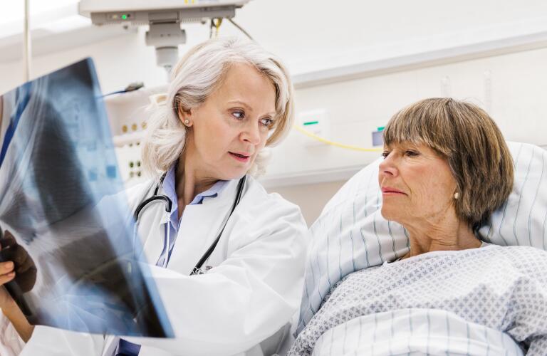 Doctor showing X-ray to patient