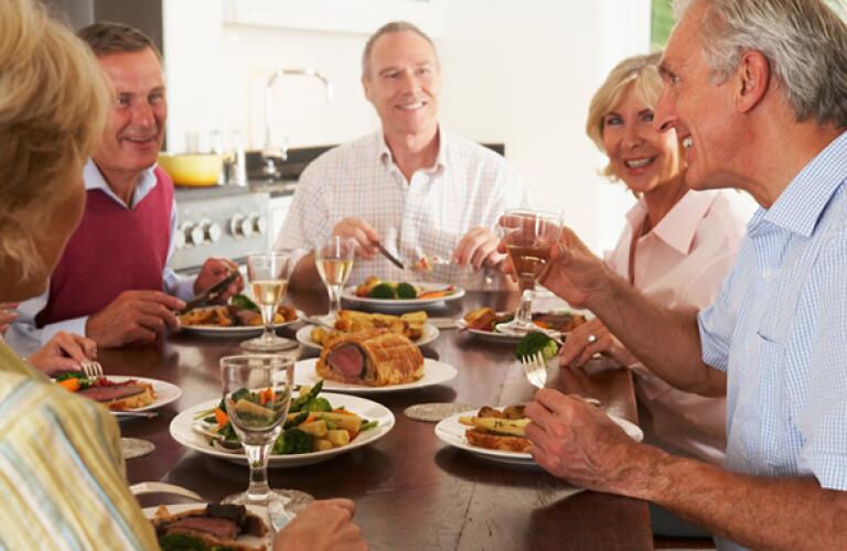 middle age friends enjoying dinner