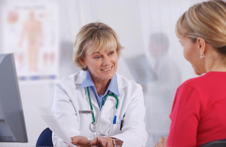 Women doctor talking with female patient