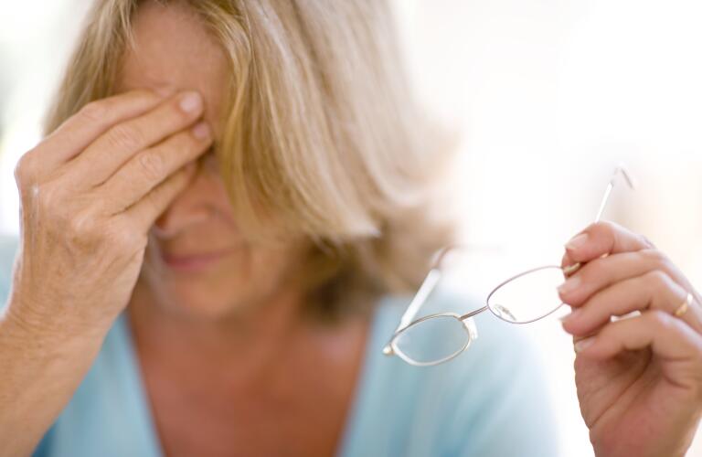 Woman rubbing eyes