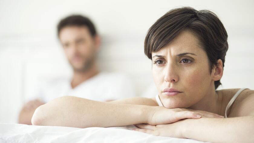 unhappy couple in bed