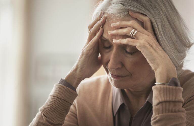 senior-woman-with-hands-on-head