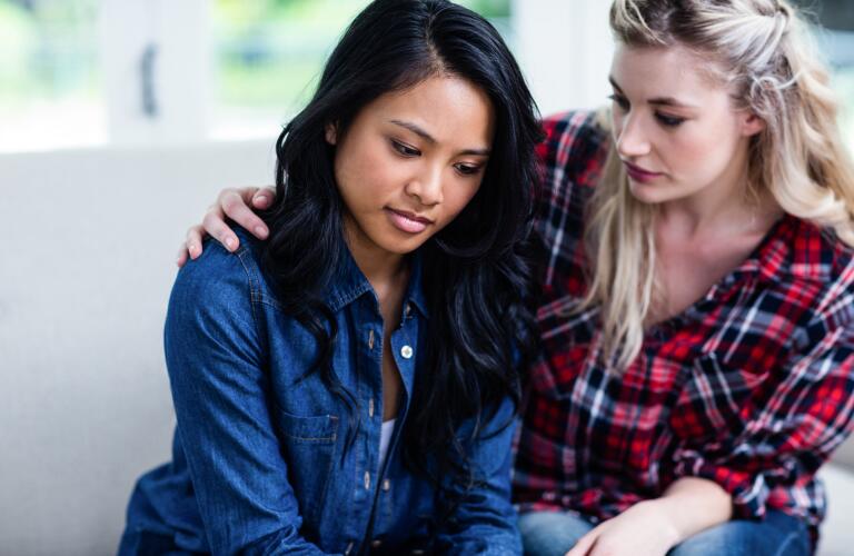 Woman consoles her friend