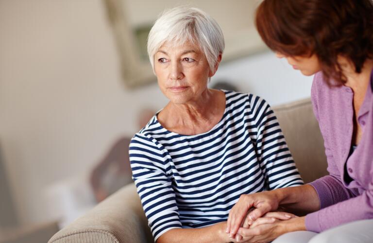senior woman holding hands of caregiver