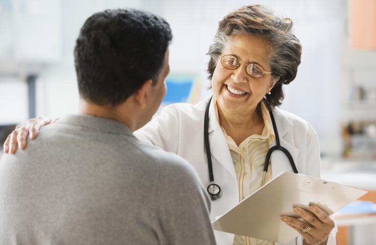 female doctor comforting male patient
