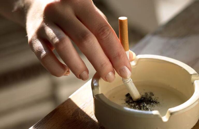 Stubbing out cigarette