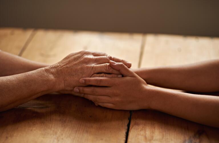 hands-holding-on-table