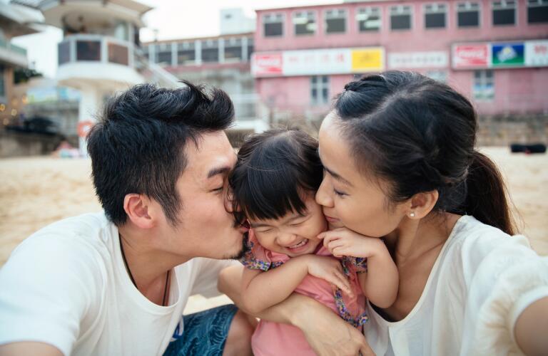mother and father embracing child