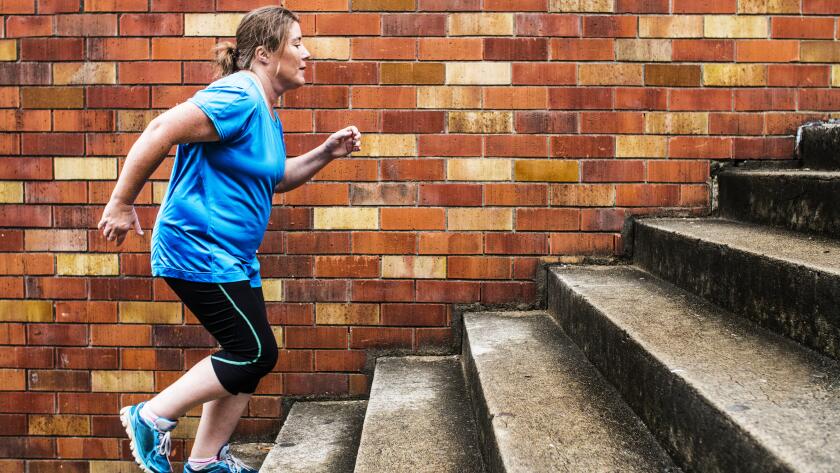 Woman jogging up stairs