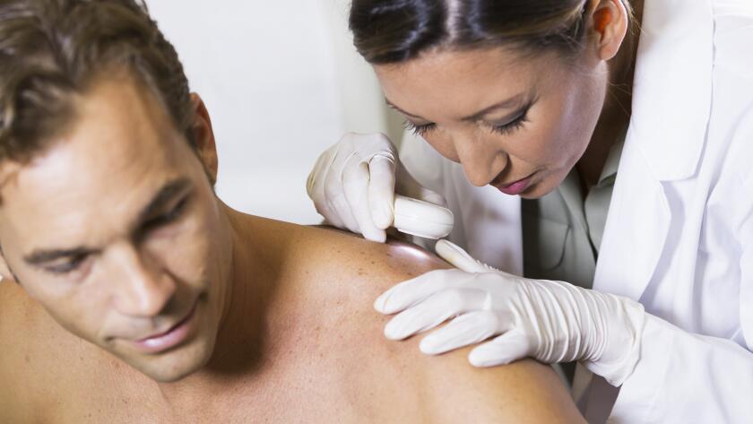 Doctor examining patient's back