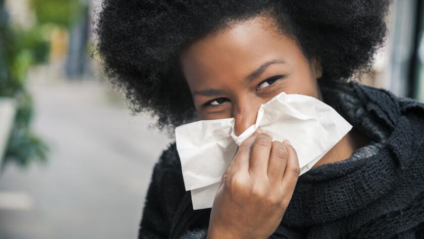 woman-on-street-sneezing