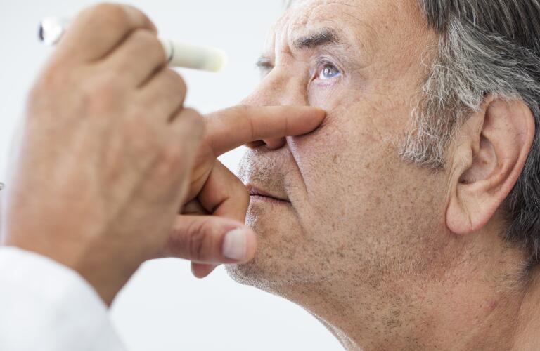 Elderly man examined by an ophthalmologist