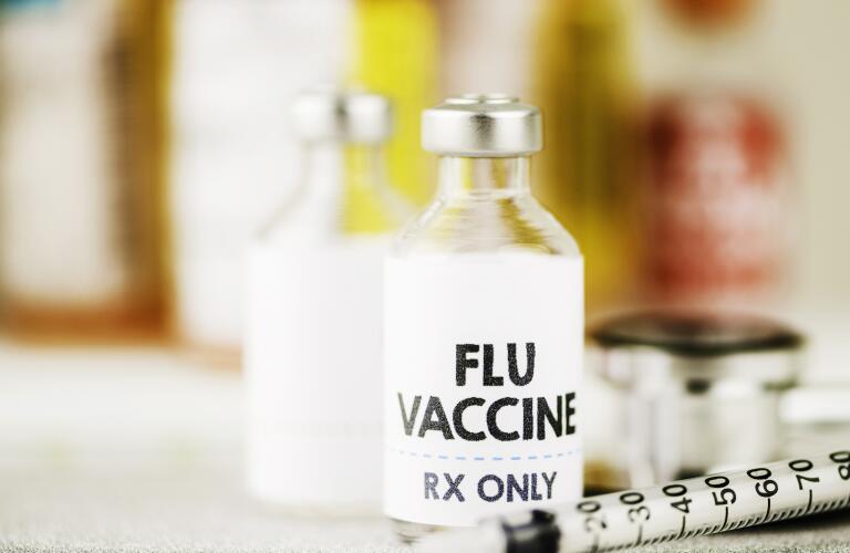 Flu vaccine with syringe and stethoscope