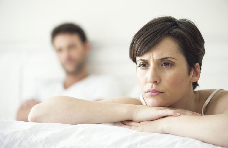 unhappy couple in bed