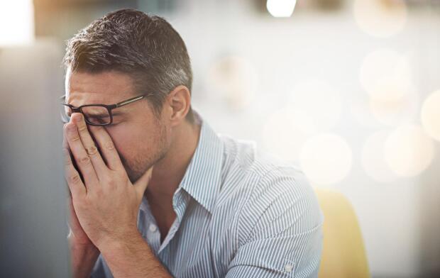 exhausted-man-with-hands-in-face