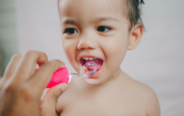 baby girl having teeth checked