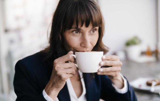 woman drinking cup of coffee