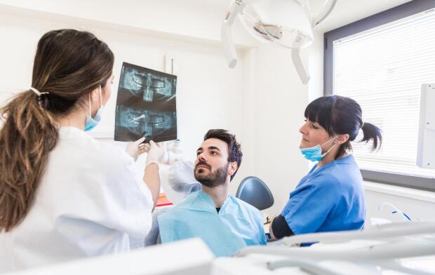 dentist showing x-rays to patient