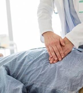 doctor examining patient's stomach