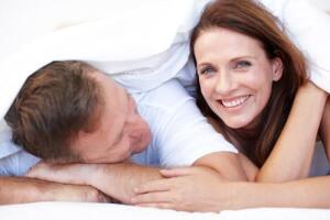 Mature-husband-and-wife-lying-in-bed-together
