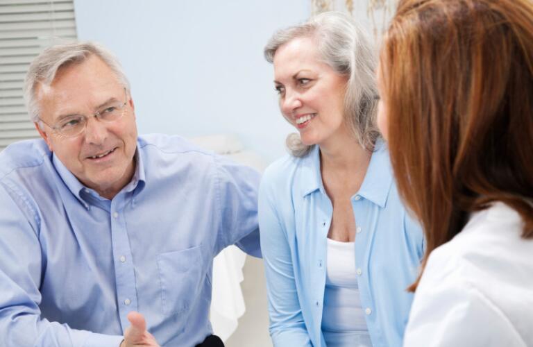Mature Adult Couple In Conversation With Doctor
