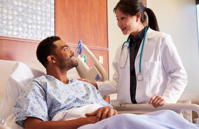 Female doctor talking to male patient