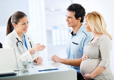 Pregnant young couple in doctor's office