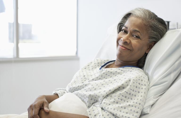 Woman smiling in hospital bed