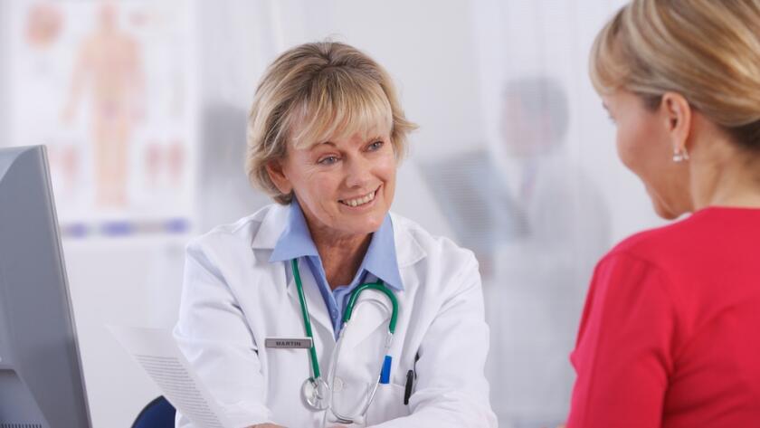 Women doctor talking with female patient