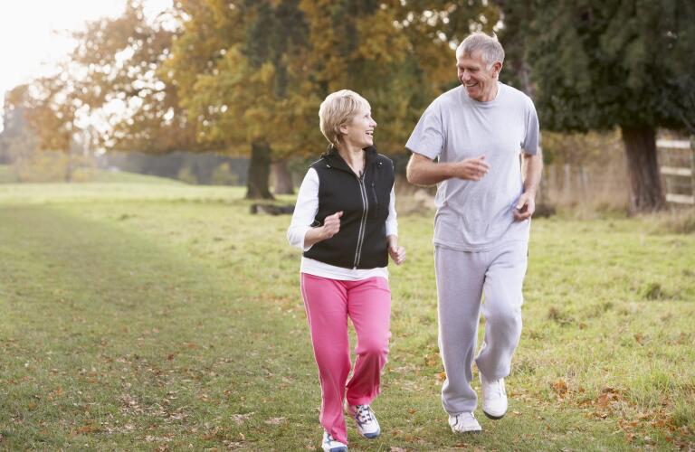 couple-power-walking-in-park