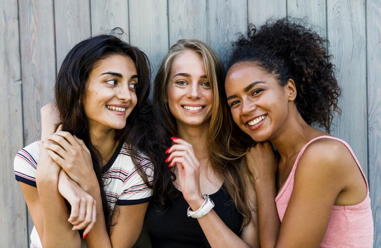 Group of diverse young women smiling together
