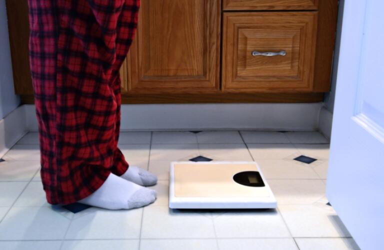 Man Standing in Front of Bathroom Scale