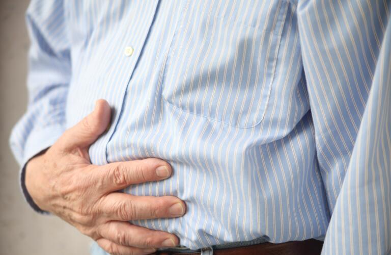 male holding stomach