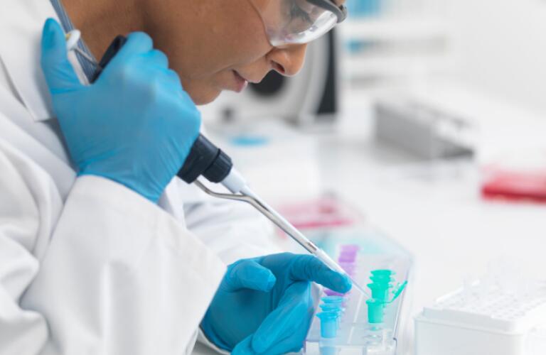 Female scientist pipetting DNA samples for testing