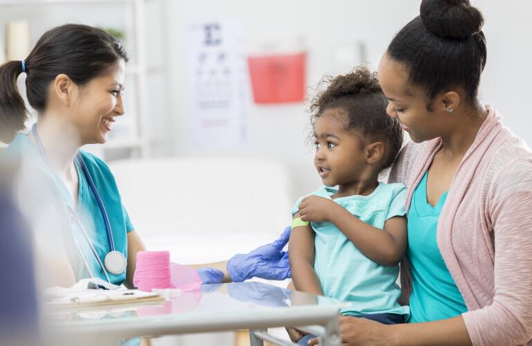 Young African American girl and mother at doctor