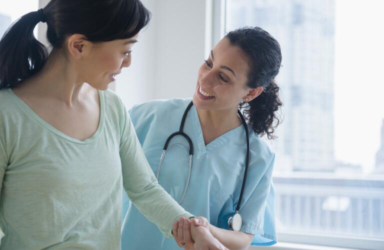 Nurse helping patient in hospital
