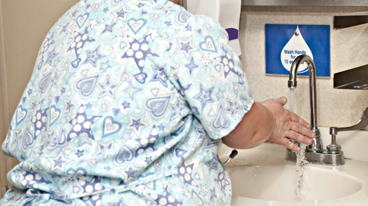 Pregnant nurse washing hands