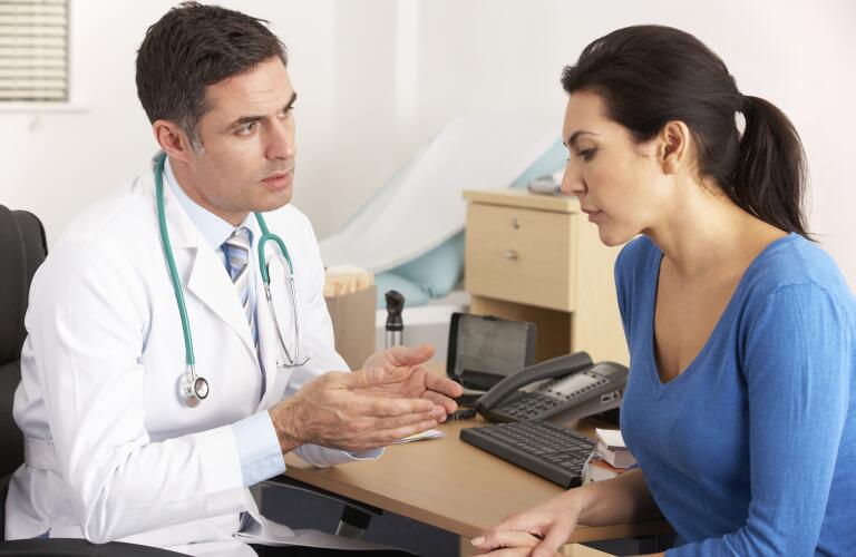 American doctor talking to woman in surgery