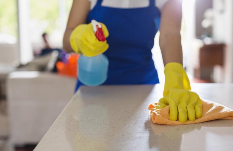 woman-cleaning-kitchen-counter