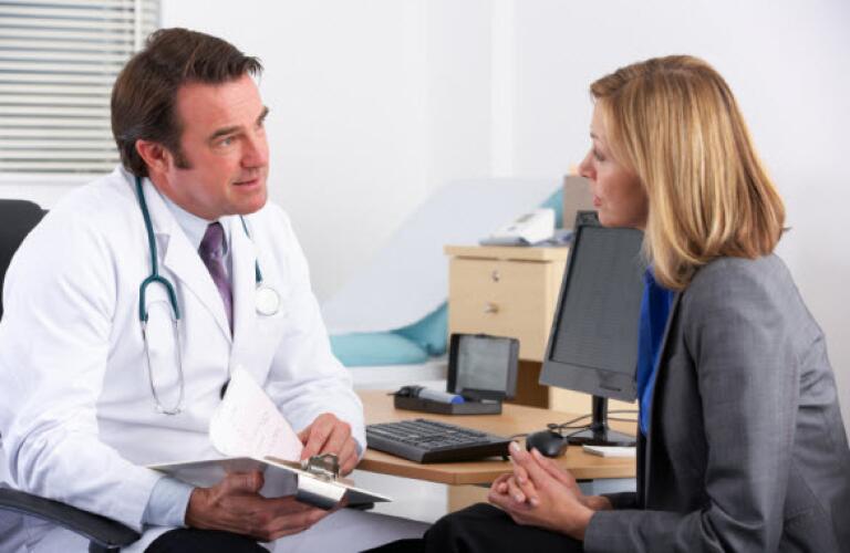 Woman talking to doctor