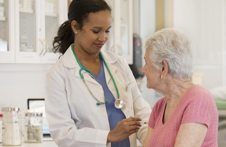 Doctor giving patient vaccination